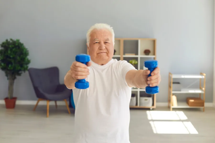 Elderly man lifting weights