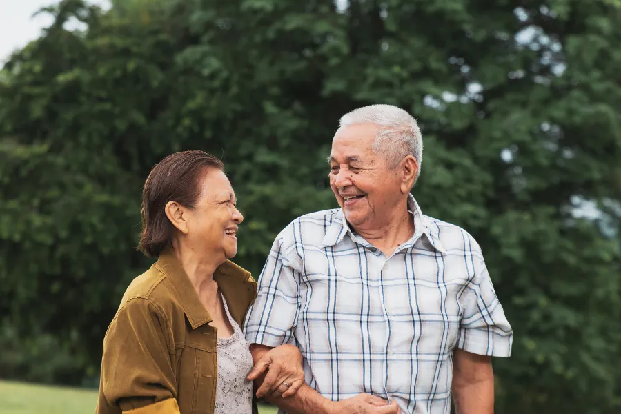 elderly couple walking outdoors