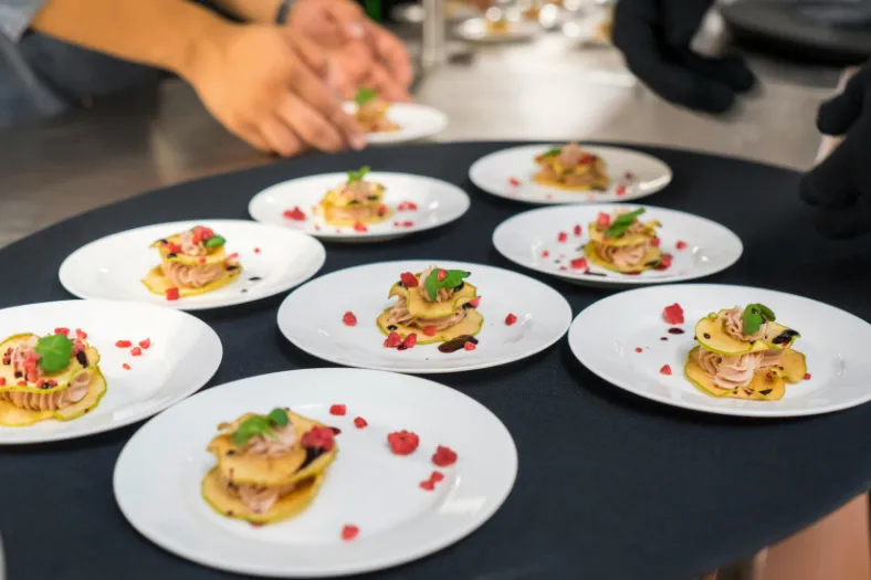 Chef preparing plated gourmet meals in a senior living dining program in Winter Haven