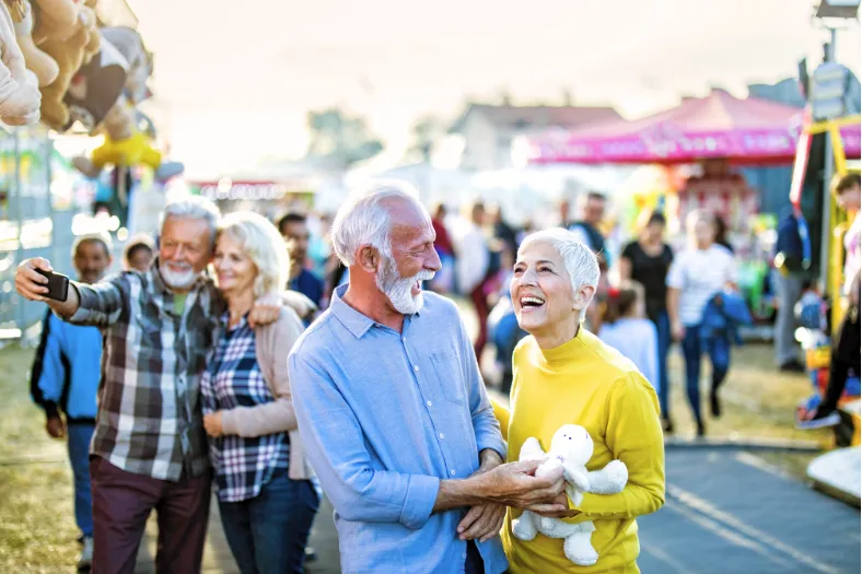 Senior couple enjoying a lively outdoor community event in a Winter Haven independent living setting